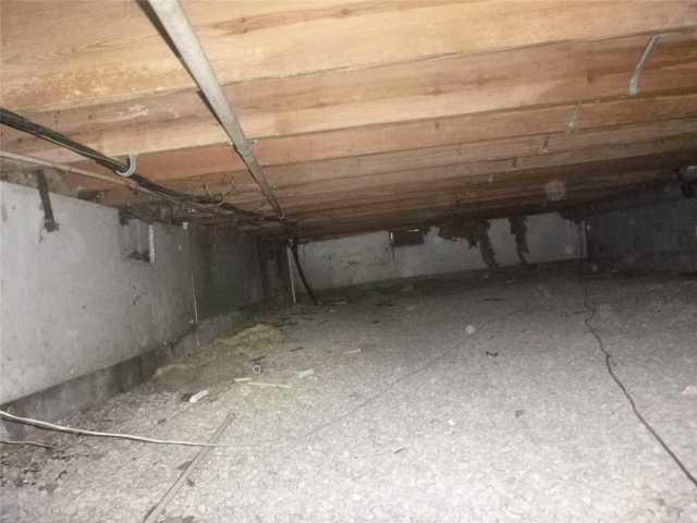 This is a typical crawlspace in need of a moisture barrier and dehumidification