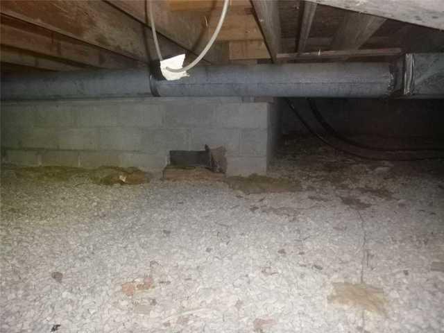 This is a typical crawlspace in need of a moisture barrier and dehumidification