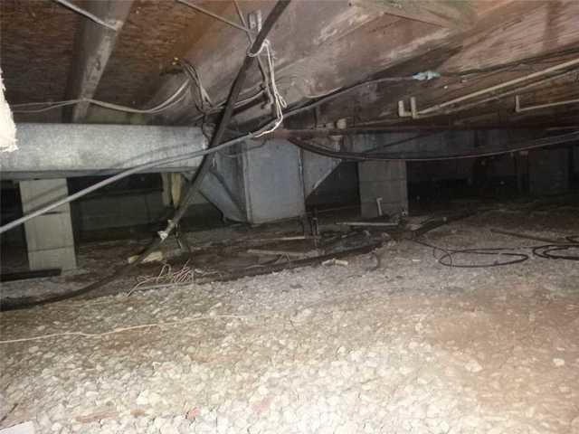 This is a typical crawlspace in need of a moisture barrier and dehumidification