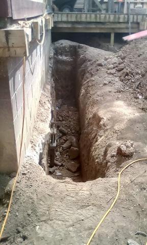 Foundation Repair in Milan, MI Trench dug for piers