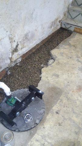 A sump pump was installed and surrounded with special engineered fill for the drainage system