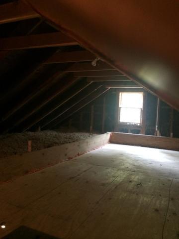 <p>A half open, half platform attic. A barrier was built around the deck and sealed, ensuring that no insulation falls through. The deck has cellulose insulation dense-packed underneath, both providing a thermal barrier and preventing air leaks. Then, loose fill cellulose is added to the areas around the platform, to the reccomended R-value of 48-60.</p>