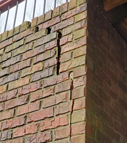 Stair-step cracking at the corners is a common sign that the problem is getting worse. As the wall starts bowing, it's a race against the clock.