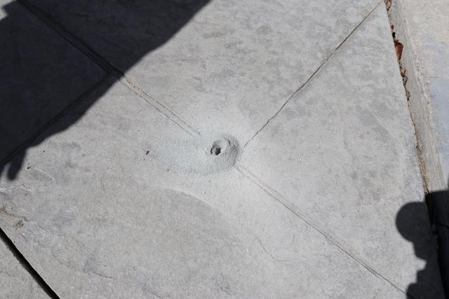 These dime-sized holes are used to inject the polyurethane before being resealed with fresh concrete