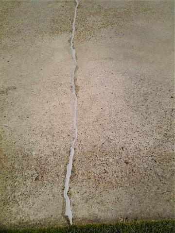 <p>Cracks sealed by the Quality 1st crew! Now this driveway is safe to walk on.</p>