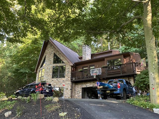 Front View of Home with old roofing materials.