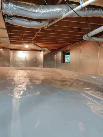 After cleaning up the crawl space, we installed our CleanSpace vapor barrier along the floor and parts of the walls to keep moisture out of the air.