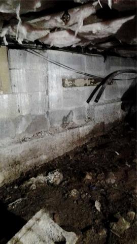 <p>Mud on the floor and dark stains on the wall are evidence that this home is in big trouble.</p>