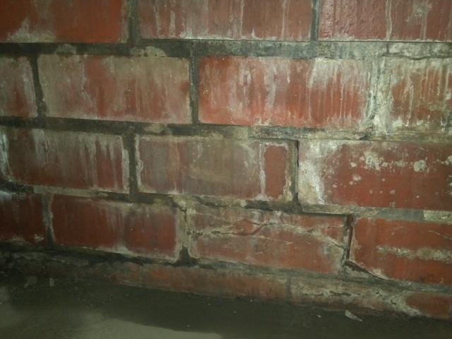 <p>In this photo you may notice the cracked grout line on the block wall and is a repairable structural defect. More photos in this album will show in addition to wall cracks, bowing and twisting walls as well.</p>