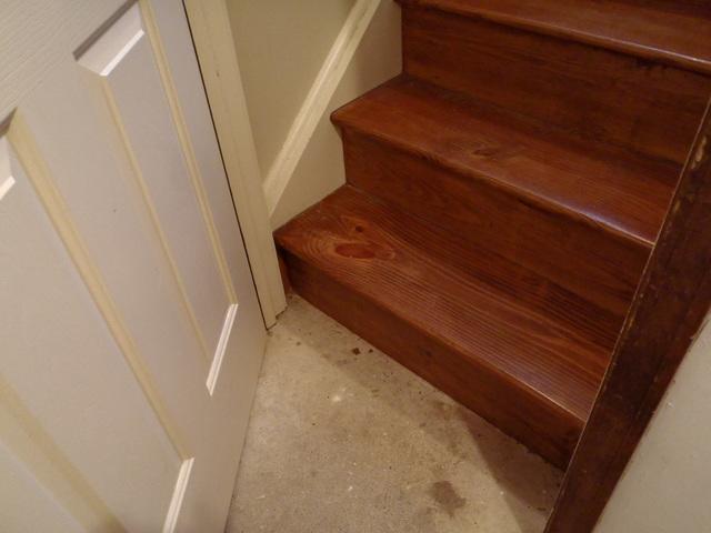 Photo of the dull cement flooring found in this home. Keep browsing our photos to see the finished product! 