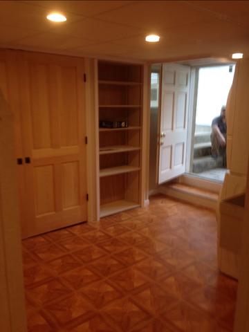 After photo showing built in shelving with the washer and dryer to the right. 