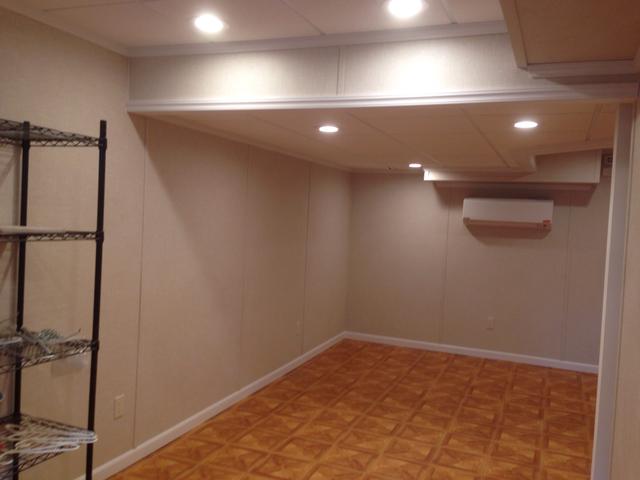 After picture featuring beautiful flooring, installed ceiling lighting and a lot more usable space! 