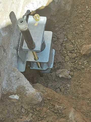 Under Footing bracket.