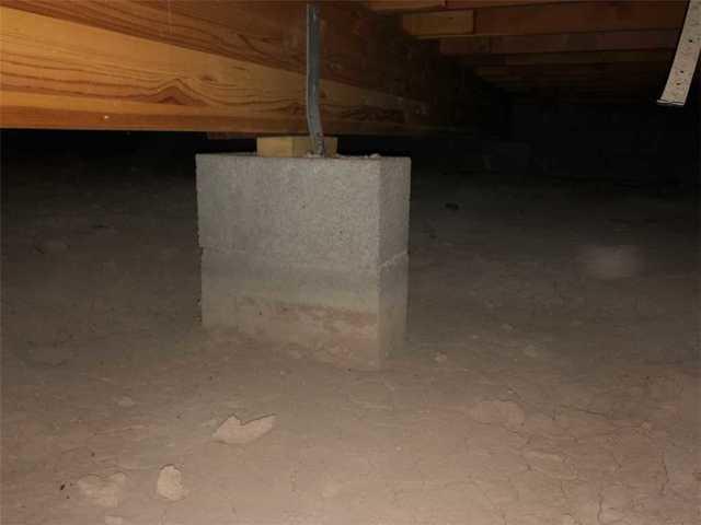 <p>In this photo, we can see that the cinder blocks supporting the crawlspace are sinking into the soil below right before our eyes.</p>