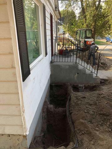 Our crew exposed the footing of the home to install brackets to hold the piers in place