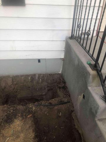 Settlement has caused a crack in the foundation near the sinking front porch.