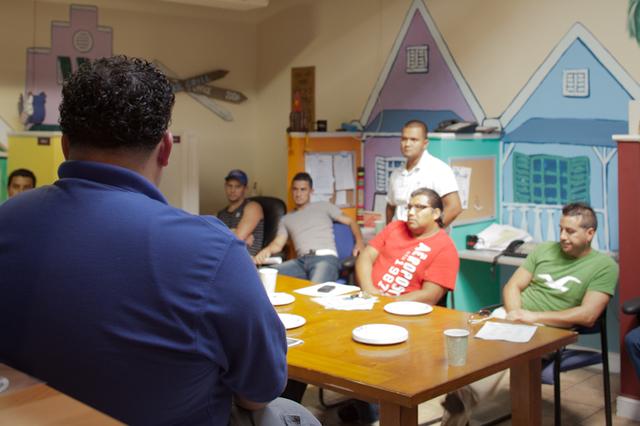 Juan and the members of each team look on.