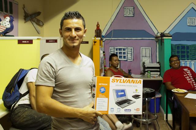 Heriberto shows off his prize for fastest assembly time, a new netbook!