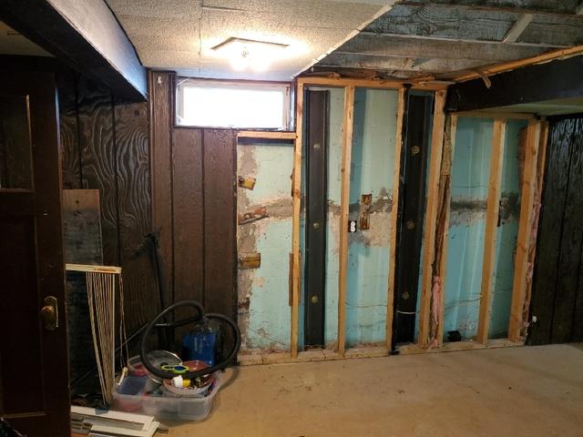 Before Photo - Water Damage and Bowing Walls