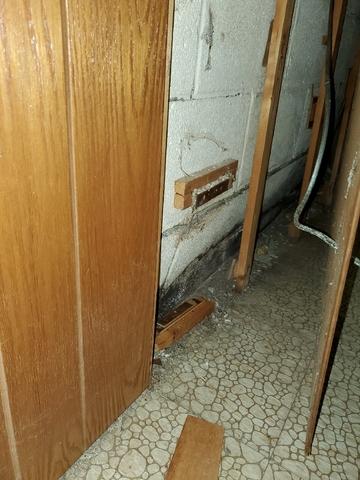 Before Photo - Cracked Walls Hidden Behind Paneling