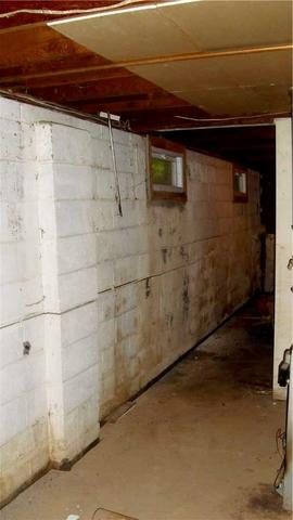 <p>This Bridgewater basement had long cracks along the wall. The wall bows inward compromising the structure of the home.</p>