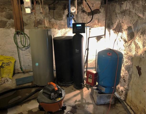 The drain system is able to navigate around important utilities like basement water heaters.