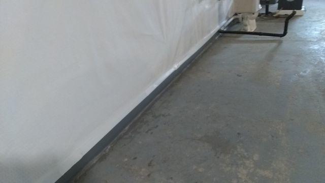 We installed our moisture vapor barrier against the wall of the foundation to stop moisture and water seepage. The CleanSpace Vapor Barrier is then tucked into the French drain system known as WaterGuard to collect and direct water to the pump.