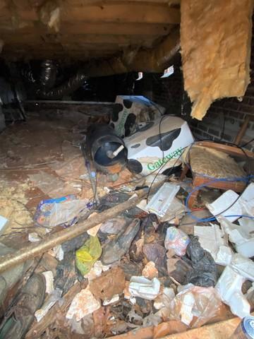 Piled Trash in Crawl Space