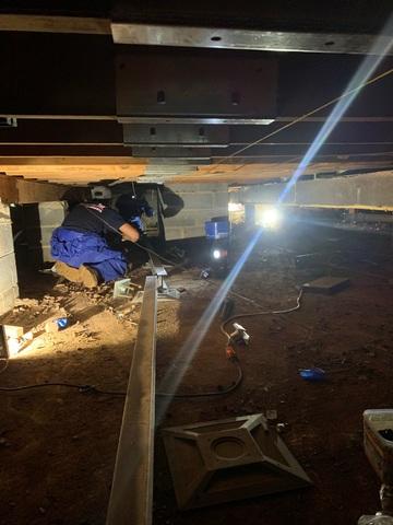 Foreman, Mario and his team began working to prep the crawl space area for each individual SmartJack that needed to be installed against each sagging beam.