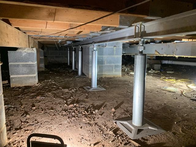 SmartJacks are an adjustable pier that is installed against the crawl space beam and floor joist to provide additional support to the floor above. Gradually over time the beams can be brought back towards the original level.