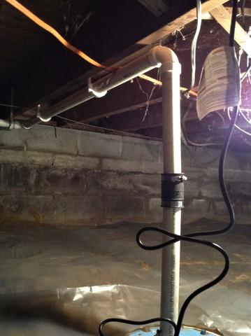 The sump pump funnels water away from the foundation.