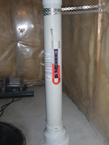 <p>Radon mitigation pipe our of the ground.</p>