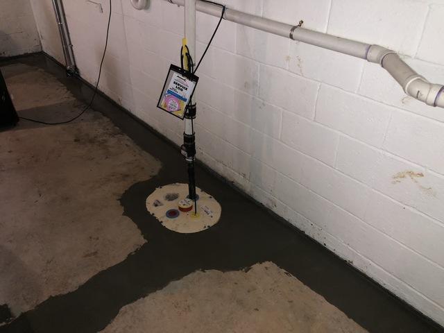 The perimeter system was installed, covered with new concrete, and the Super Sump installed and discharged out using PVC piping. The system will ensure the basement area stays dry.