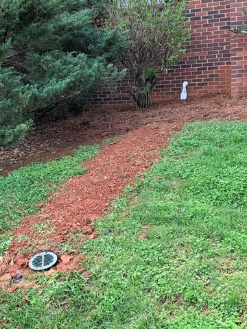 The discharge line out of our system is a French drain that keeps water away from the base of the home.