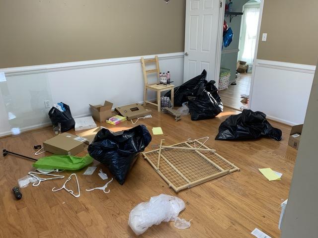 Before - chairs, bags of trash, boxes, and other household items need to be sorted through and donated or recycled.