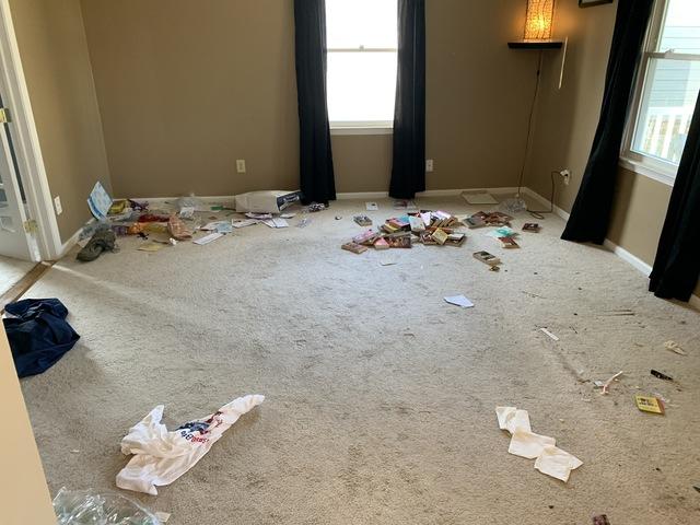 Before - small items including books, linens, and other small items are littered throughout the room and need to be sorted.
