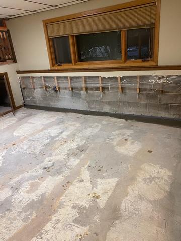 Our crew removed the damaged drywall and moldy carpet to get to the concrete basement floor. They then installed the interior waterproofing drain system along the perimeter wall here.