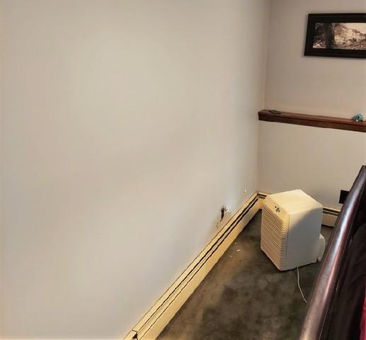 After water damage to the dry wall and carpet in this basement, the homeowner was looking for a permanent solution to basement water issues.