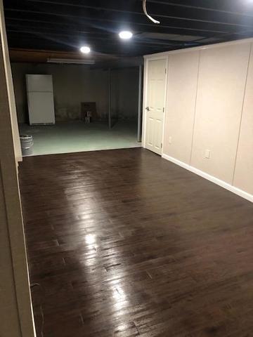 <p>Our EverLast Walls, Elite Plank Flooring, and 6 Panel Doors look fantastic in this basement. The overhead recessed lighting in the painted ceiling makes this space glow. In this picture you can see the stark contrast between the finished area and the unfinished area in the basement.</p>