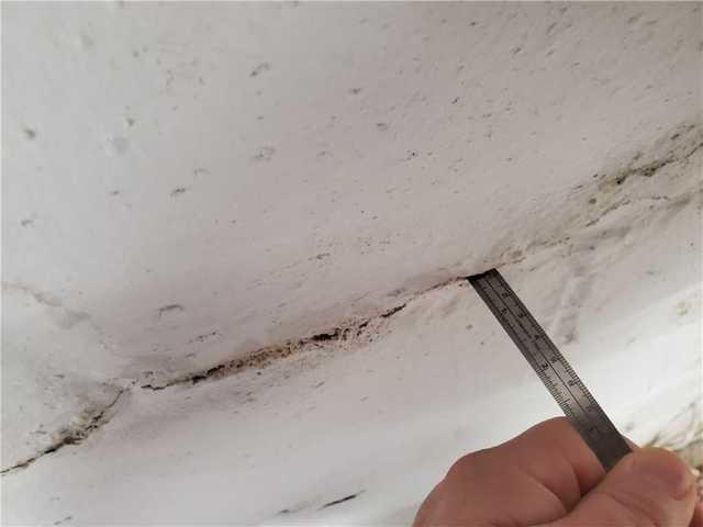 Upon inspection Greg noticed small hairline cracks horizontally across the foundation wall.