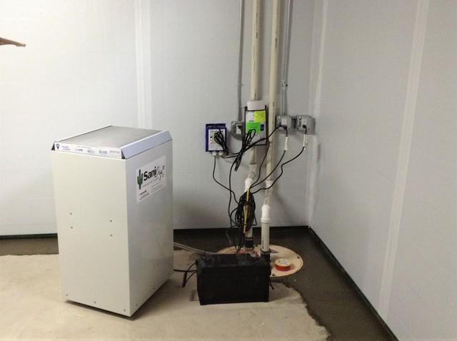 An interior drainage system, sump pump, and dehumidifier were installed to solve the water issues.