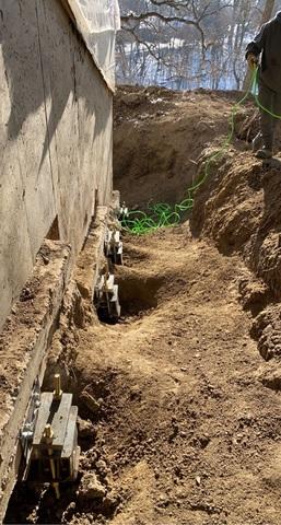 Our team installed 4 push piers on this side of the home to permanently stabilize the home and return it to a level postition.