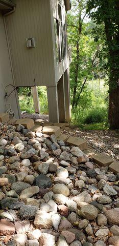 The back deck as seen in this photo is settling, causing issues on both the interior and exterior of the home.