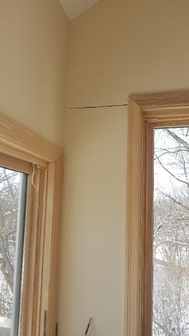 Cracks in the dry wall commonly occur at the tops of doors and windows. This happens as the wall is shifting but the door and window frames hold their shape. Often times, this makes it difficult to open doors and windows.