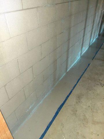 This photo shows PermaFlex basement waterproofing on the concrete block wall. This will keep moisture from penetrating through the walls into the basement.