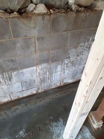 This photo shows how water was able to leak through the concrete block walls into the basement, creating a moisture issue