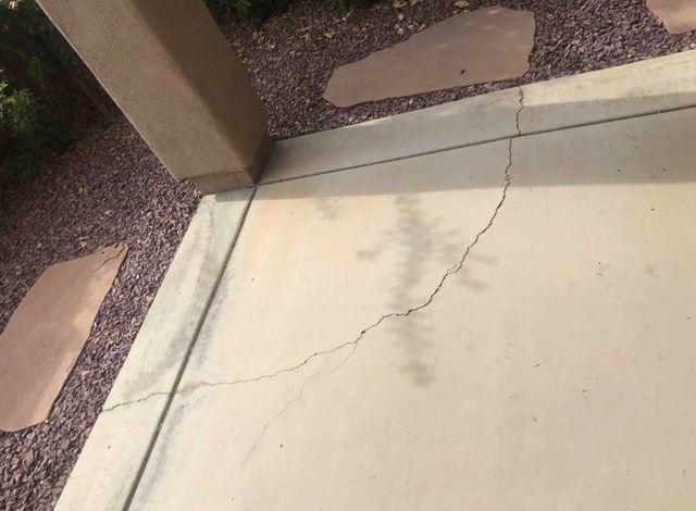 Cracks in concrete slabs, like patios, garages or driveways, is another sign of stress.