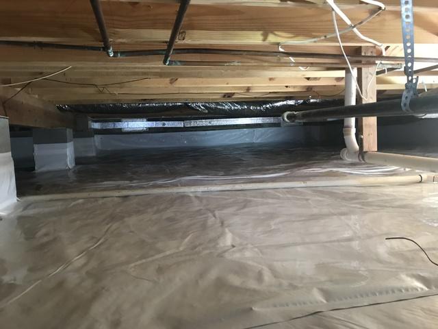 A heavy-duty 20-mil CleanSpace liner was used to cover the flooring of this crawl space. This vapor barrier helps to prevent moisture from rising into the crawl space and increasing the relative humidity. It gets wrapped around all piers and mechanically fastened to the foundation walls six to eight inches above outside grade. An antimicrobial called UltraFresh is built into the 7-layer polyethylene liner to help prevent mold and mildew growth on the vapor barrier itself.