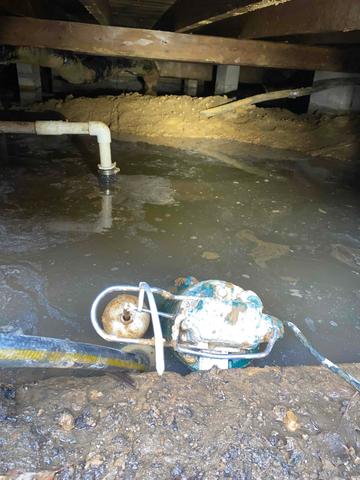 This water had been pooling in the crawlspace, creating a lot of moisture and mold. Here, it was being pumped out before the work started.