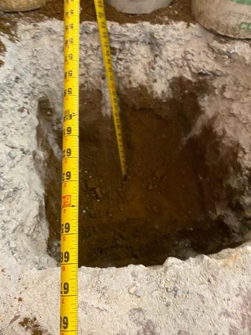 First, the soil is to be removed where the SmartJack system will be placed. The hole is filled with concrete or engineered fill to create a stable footing.